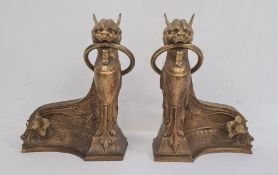 Empire style  gilt bronze chenets each in the form of sphinx with ring in mouth and on sweeping