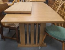 20th century light oak extending dining table on pillar end supports