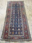 Eastern runner, the dark blue ground with foliate medallions, on a stepped red ground border,