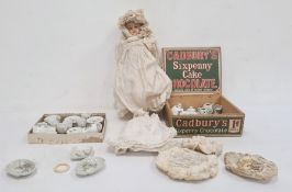 Antique composition shoulderhead doll with blue sleeping eyes, painted features, wearing cream