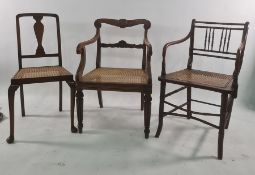 Five assorted chairs to include cane seated spindle back chair, rush seated chair, wheelback chair