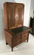 20th century oak desk / dressing cabinet, leather writing surface revealing inkwells, the upper