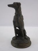 Bronzed figure of a seated greyhound, on circular base, marked F Souchal Paris to base, 17cm high