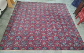 Large modern machine made red ground rug with all-over repeating green and blue pattern, 205 x