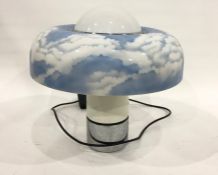 Large 1970's plastic table lamp with circular shade of blue sky and clouds, on cylindrical base with
