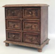 Miniature chest of six short drawers, rectangular top with moulded edge, the whole raised on