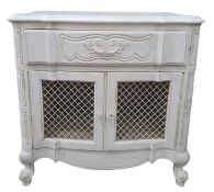20th century white painted cupboard, the shaped top above single drawer, two grilled cupboard doors,