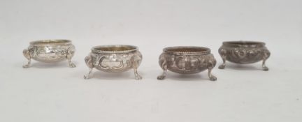 Set of four Victorian silver salts, cauldron shaped, each floral embossed and on three paw feet,