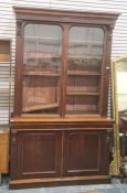 Late 19th century mahogany bookcase cabinet with ogee moulded pediment, above two glazed doors