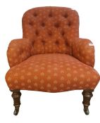 Late Victorian chair with pink button back upholstery, on turned front legs to black china castors
