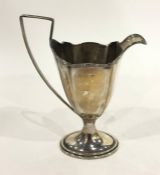 Edwardian silver cream jug of revived Georgian style, oval, footed with thread edge and on oval