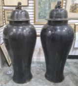 Pair of large Oriental floor standing porcelain covered meiping vases, each with dog of fo finial to