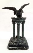 Bronzed metal statue of an eagle atop pillared ruins, on rectangular marbled base, unsigned, 33cm