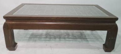 Rectangular coffee table with glass top covering the latticework design, the whole in the Chinese