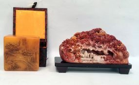Simulated soapstone resin carving of wooded scene and the hardwood stand, 23cm side and a variegated