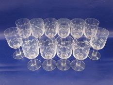 Set of 12 large Orrefors clear glass wines with floral etched design, on thick column stems and
