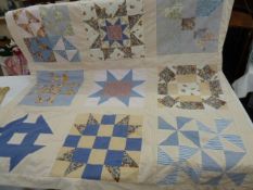 Modern patchwork quilt showing the various American quilt patterns, and modern patchwork hanging