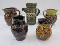 Five studio pottery jugs, one green glazed jug with studio pottery mark 'BP' to base, a Winchcombe