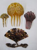 Three carved tortoiseshell and faux-tortoiseshell hair combs and a tortoiseshell folding brise