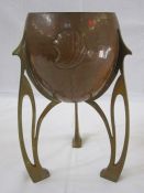 Jugendstil brass and copper jardiniere, the copper bowl shell decorated, on three brass pierced