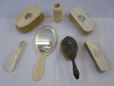 Ivory dressing table set to include mirror, clothes brush, shoe horn and two hair brushes bearing