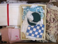 Pair of cotton sheets, assorted table linen and two vintage pinafores, one printed with the head