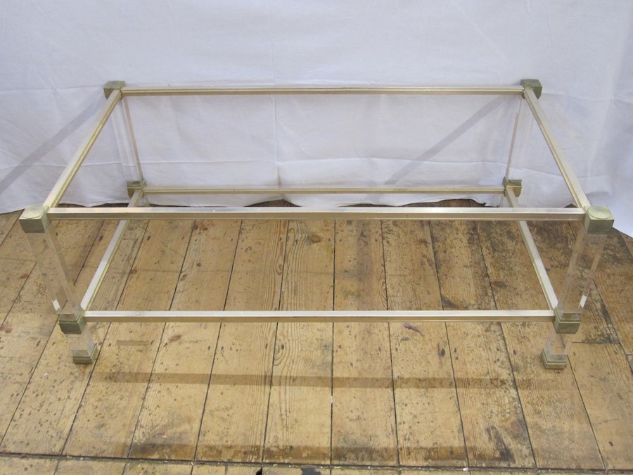A two tier coffee table by Pierre Vandel, clear perspex with metal mounts, maker's label, 99cm