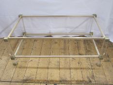 A two tier coffee table by Pierre Vandel, clear perspex with metal mounts, maker's label, 99cm