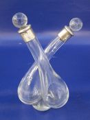 Late Edwardian silver-mounted glass double oil and vinegar decanter with clear glass stoppers,