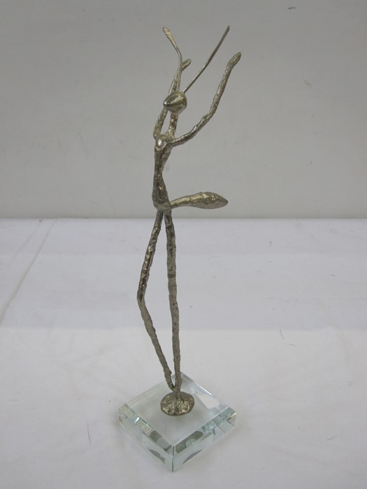 Contemporary silver-coloured sculpture, praying mantis-type model, on a square clear plastic base,