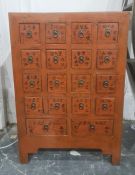 Chinese painted wooden cabinet fitted with sixteen small square drawers and two rectangular