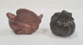 Japanese carved boxwood netsuke in the form of a sitting duck, signed on mother-of-pearl circular