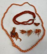 A coral graduated beaded necklace with 9ct gold clasp, coral pendants, earrings and a beaded