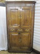18th century oak floor standing corner cupboard with cavetto cornice, upper section enclosed by pair