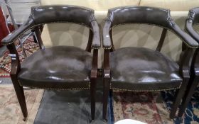 Set of four, possibly Victorian, armchairs covered in green leather, mahogany frames, to brown china