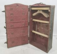 Vintage travelling trunk opening to reveal hanging space and drawers