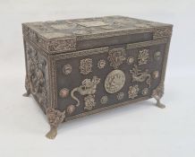 Eastern wooden casket of rectangular form, the body and hinged cover decorated with applied metal