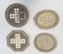 Pair Indian brass shallow dishes, each oval and embossed with dancing figures, on crawling figure