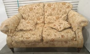 Modern three piece suite comprising a two seater sofa and two armchairs in brown floral upholstery