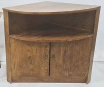 20th century oak corner cupboard, the bow front with under shelf, above two cupboard doors, plinth