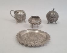 Early 20th century silver-coloured Anglo Indian three-piece cruet set (one lid missing), cylindrical