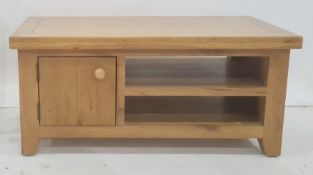 Modern pine low storage unit fitted with a single cupboard door and two open shelves, 101cm wide