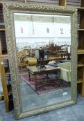 Large modern full length wall mirror of rectangular form, the mottled gilt and green frame decorated