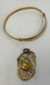 A 9ct gold christening bangle, engraved decoration, 3.7g and a 9ct gold and citrine pendant, oval