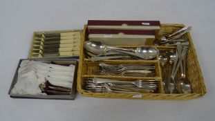 Wicker tray containing assorted plated flatware, mainly Elkington plate
