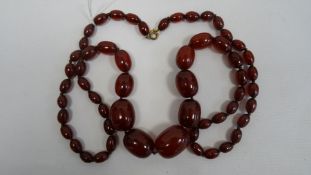 Cherry amber graduated beaded necklace, the largest bead 3cm x 2.2cm approx., the smallest 1.1cm x
