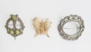 A gold coloured filigree brooch of a butterfly, a Celtic style brooch and a paste buckle/brooch (3)