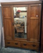 Early 20th century oak wardrobe with central mirror door flanked by decorative art nouveau inlaid