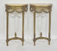 Pair of reproduction gilt wood and marble console tables, each of demi-lune design, decorated with