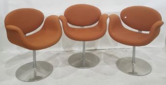 Three Artifort tulip chairs by Pierre Paulin upholstered in orange fabric on revolving aluminium